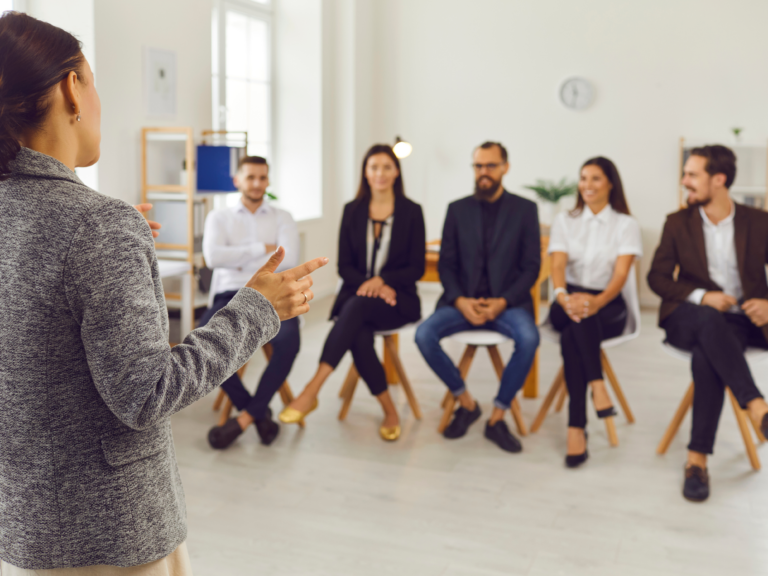 Woman presenting to a group in office meeting