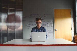 Man working at desk protecting intellectual property by not communicating.